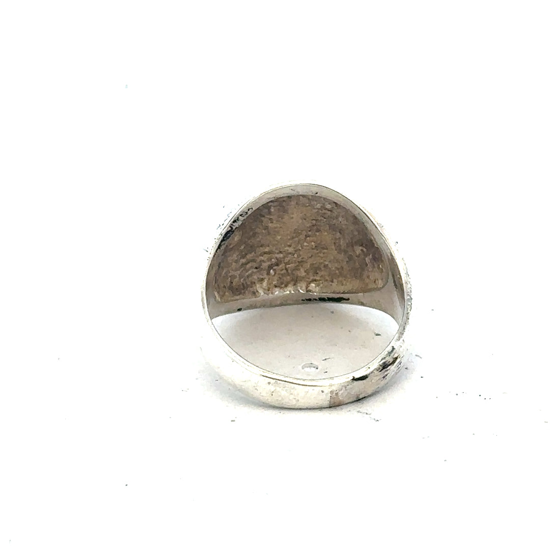 Silver signet ring in size O with a smooth polished surface, unbranded jewelry accessory.
