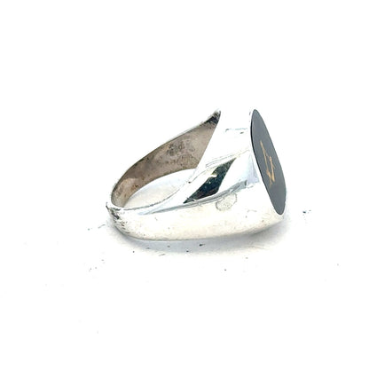 Silver signet ring in size O with a polished finish, featuring a smooth band and classic design.