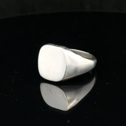 Silver signet ring in size V with a smooth, polished surface, featuring a classic design and unbranded finish.