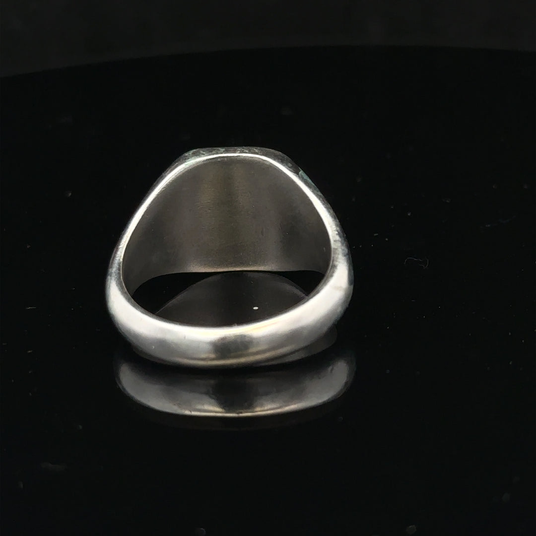 Silver signet ring in size V with a smooth polished finish, featuring a classic design and unbranded style.