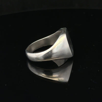 Silver signet ring in size V with a smooth band, displayed on a plain background. Unbranded jewelry accessory.