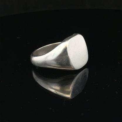 Silver signet ring in size V with a smooth band, featuring a classic design and unbranded finish.