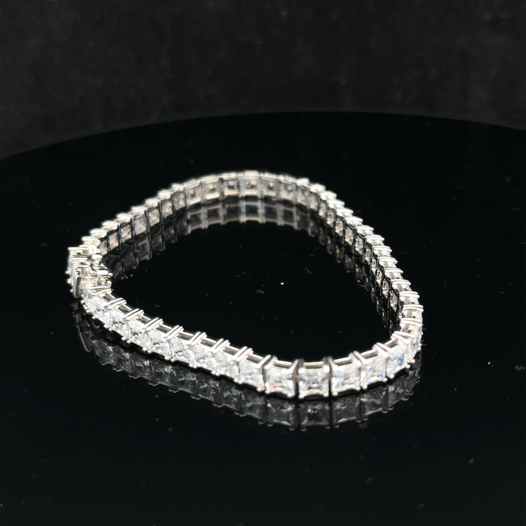 Silver tennis bracelet weighing 15.6g with linked chain design, featuring a sleek and elegant look.