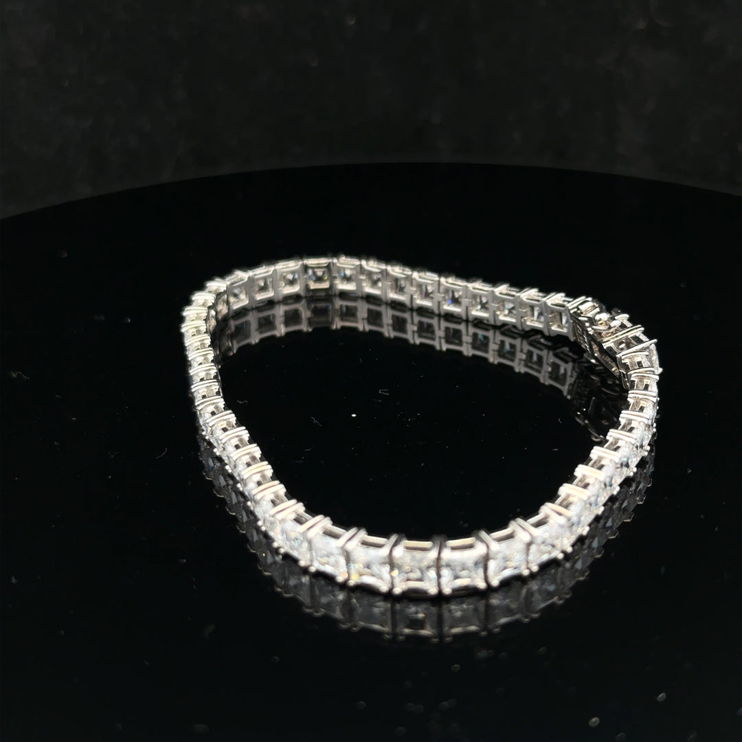 Silver tennis bracelet weighing 15.6g with a sleek, elegant design, featuring shiny silver links.