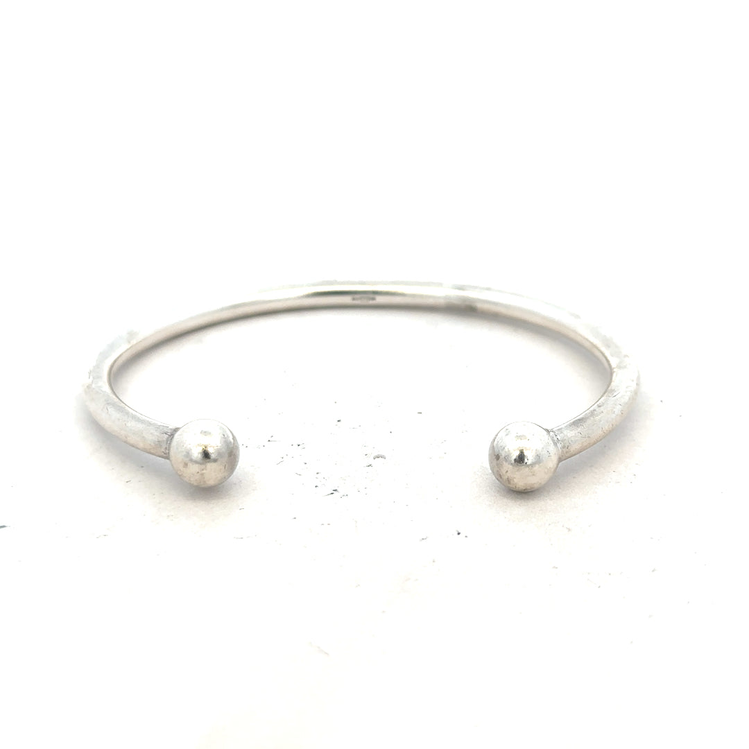 Silver torque bangle with 20g weight, unbranded, showcasing its sleek, polished metal design for stylish wrist wear.