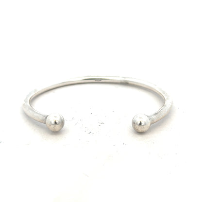Silver torque bangle with 20g weight, unbranded, showcasing its sleek, polished metal design for stylish wrist wear.