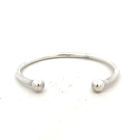 Silver torque bangle with 20g weight, unbranded, showcasing its sleek, polished metal design for stylish wrist wear.