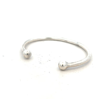 Silver torque bangle 20g with a sleek, polished design, featuring a smooth, adjustable open cuff style for unbranded jewelry.