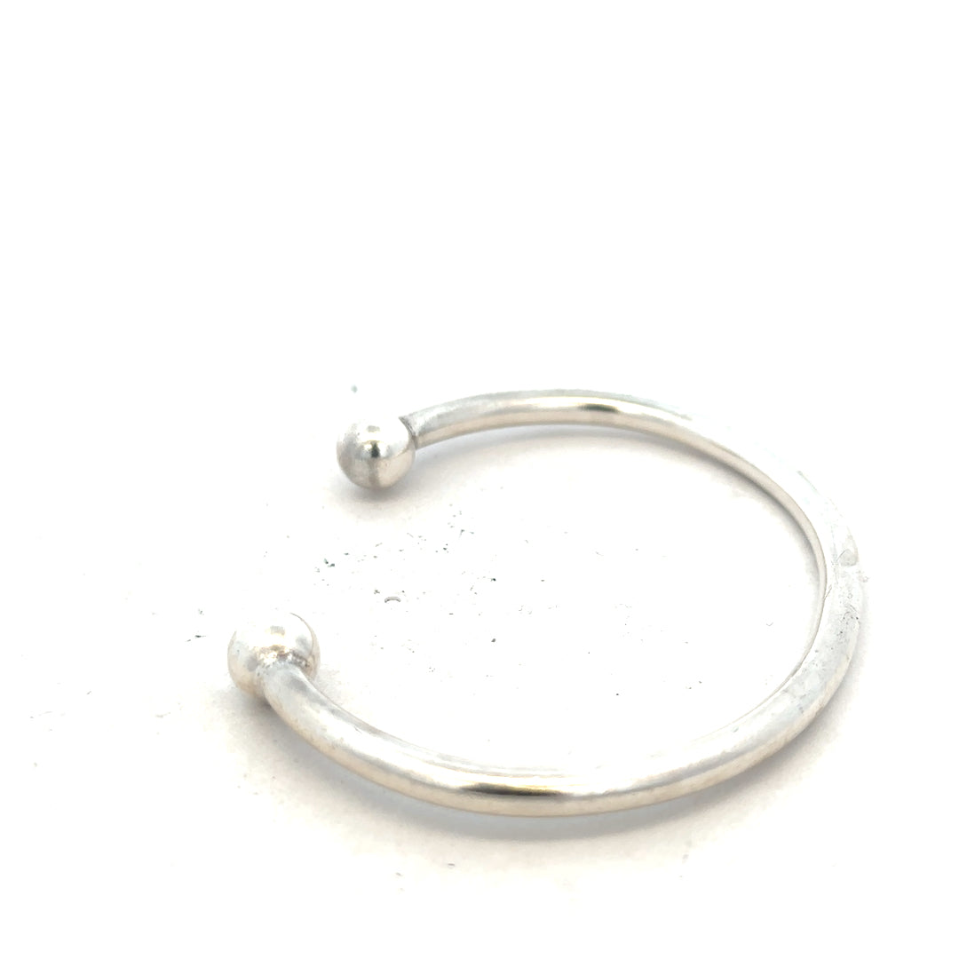 Silver torque bangle 20g, unbranded, featuring a sleek, polished design with a smooth, rounded shape for stylish wrist wear.