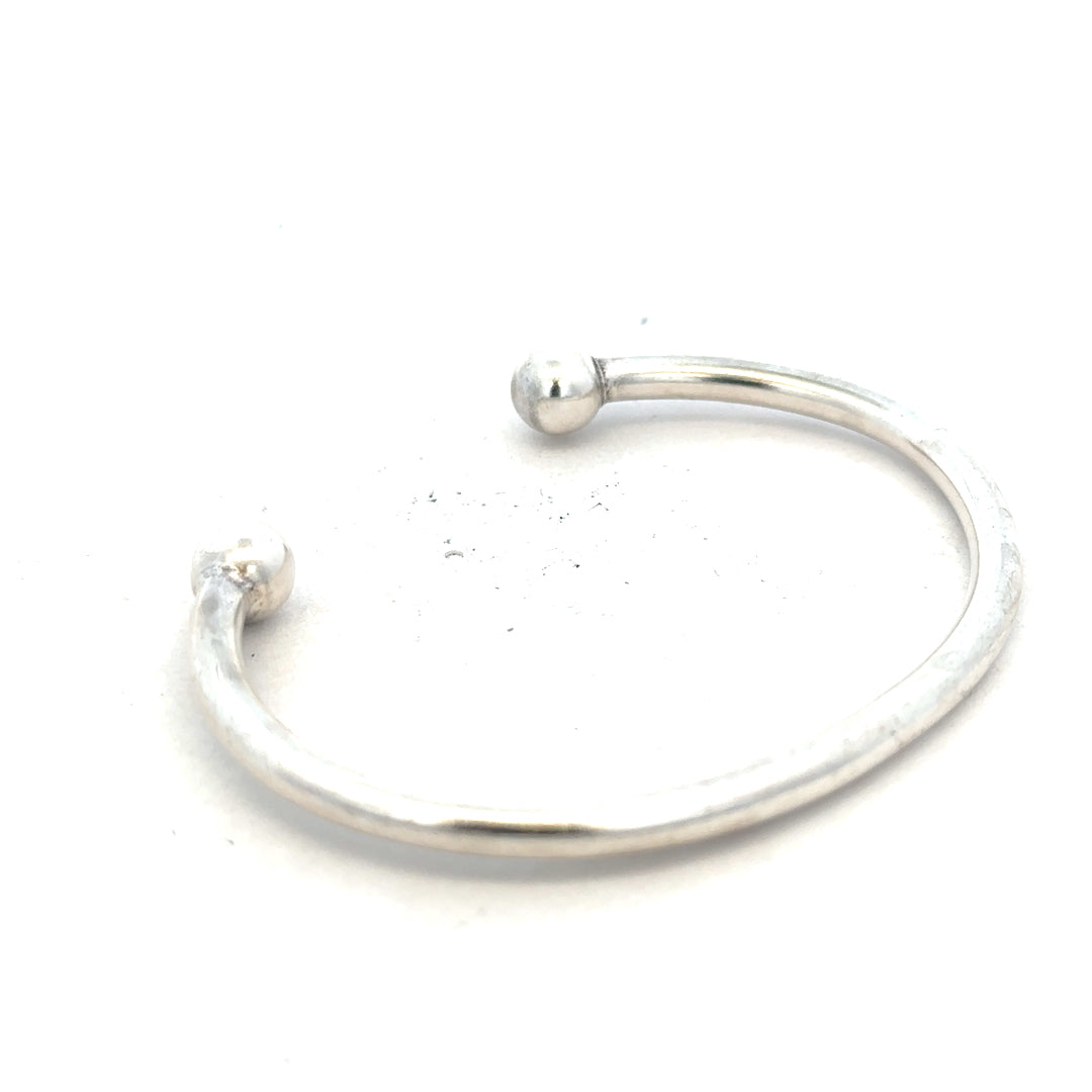 Silver torque bangle 20g with a sleek, minimalist design, featuring smooth silver finish and open-ended style.