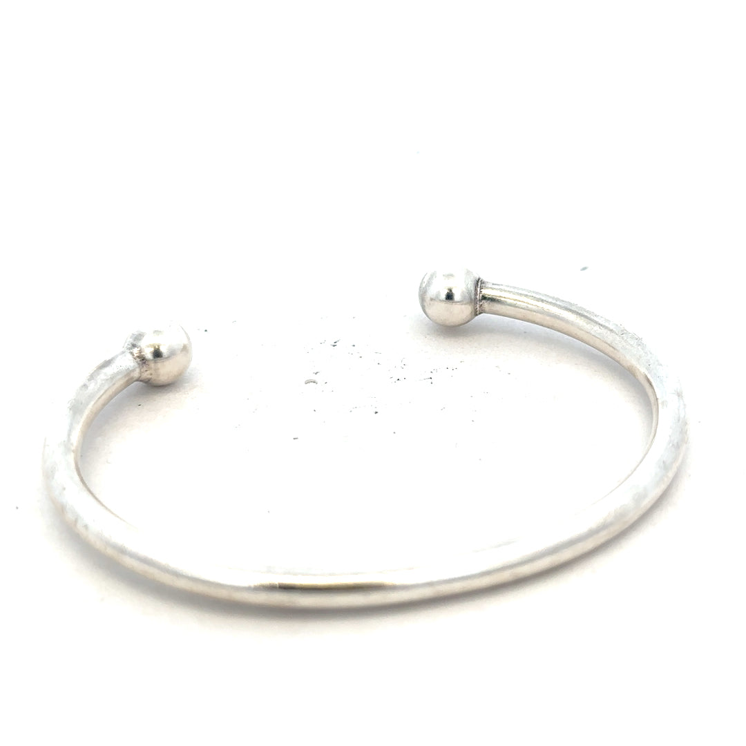 Silver torque bangle in 20g weight with a sleek, minimalist design, perfect for stylish wrist jewelry.