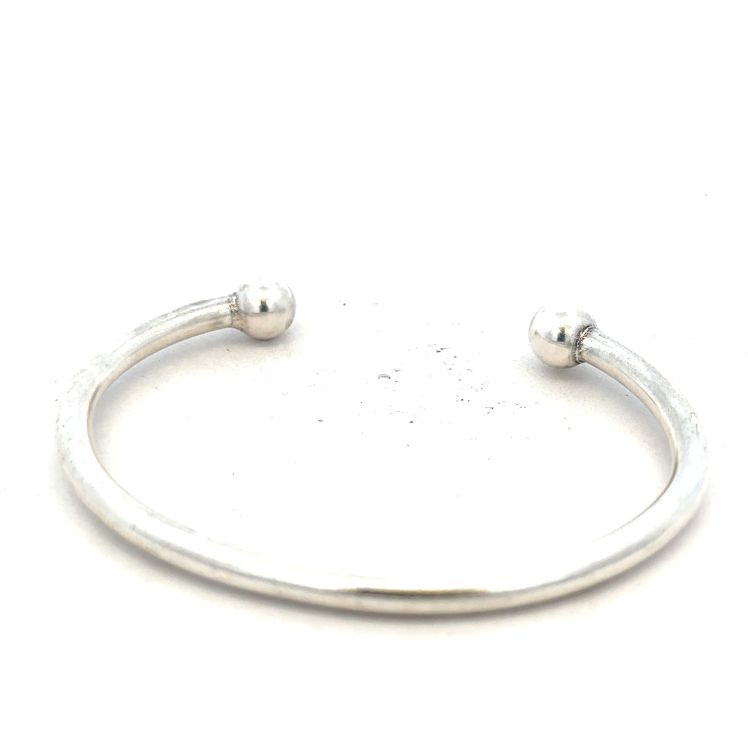 Silver torque bangle 20g, unbranded, with a sleek circular design and smooth finish, shown on a plain background.