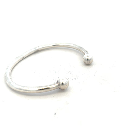 Silver torque bangle 20g, unbranded, showcasing a sleek, polished design with a smooth, rounded shape.