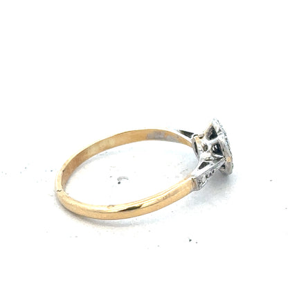 Vintage 18ct yellow gold and platinum diamond ring showing intricate design and sparkling diamonds on a white background.