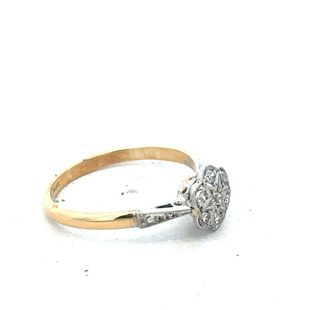 Vintage 18ct yellow gold and platinum diamond ring, showcasing intricate design and sparkling diamonds.