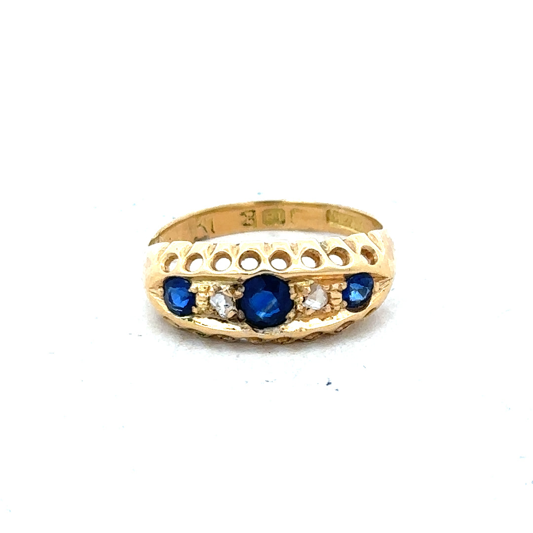 Vintage 18ct yellow gold sapphire and diamond ring with intricate design, featuring a central sapphire gemstone and surrounding diamonds.