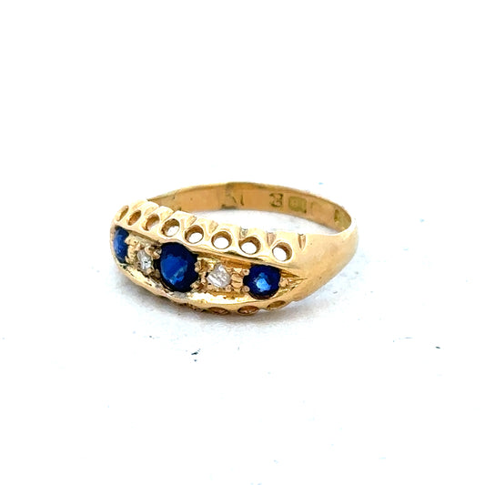Vintage 18ct yellow gold sapphire and diamond ring showcasing a central sapphire gemstone surrounded by sparkling diamonds.