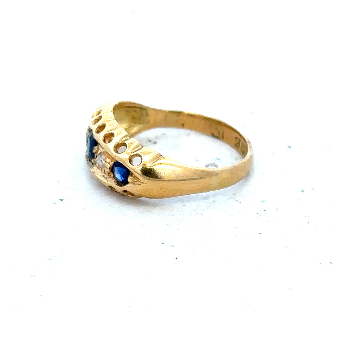 Vintage 18ct yellow gold sapphire and diamond ring with intricate design, featuring a central sapphire gemstone and sparkling diamonds.