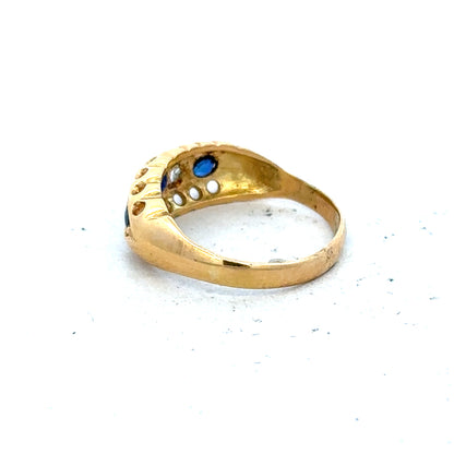 Vintage 18ct yellow gold sapphire and diamond ring with intricate design and sparkling gemstones.