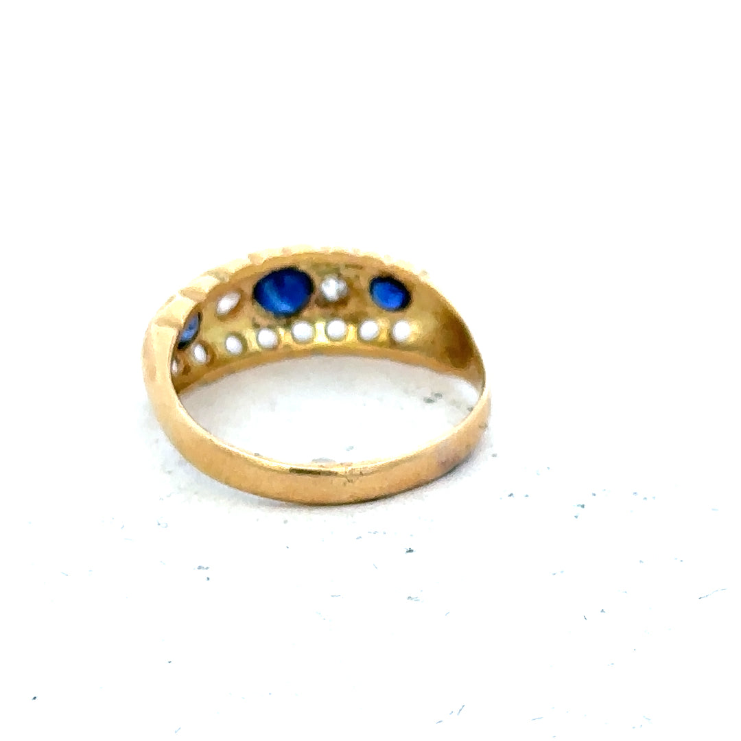 Vintage 18ct yellow gold sapphire and diamond ring showcasing a central sapphire surrounded by sparkling diamonds.