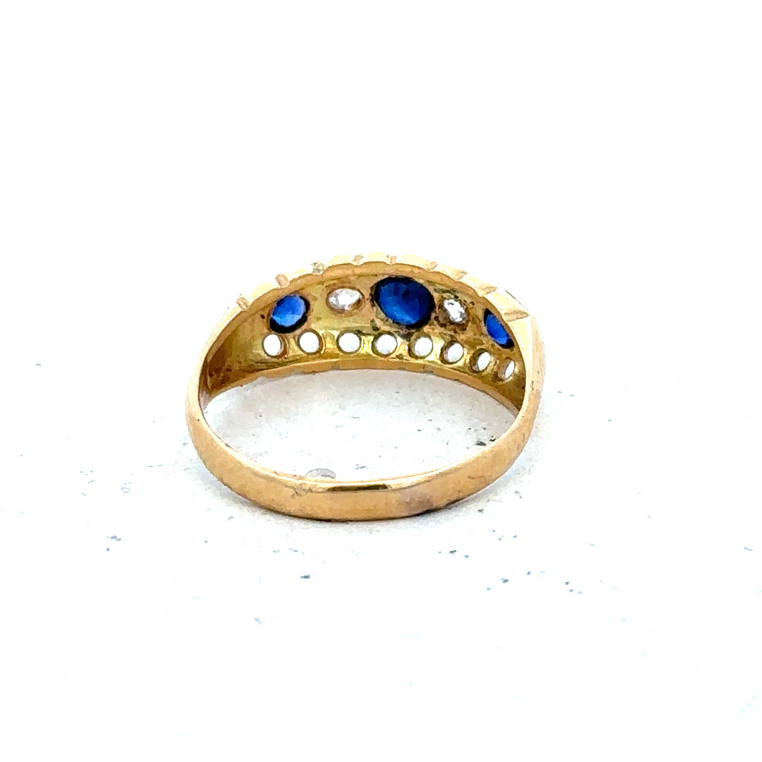 Vintage 18ct yellow gold sapphire and diamond ring with intricate design and gemstone detailing.