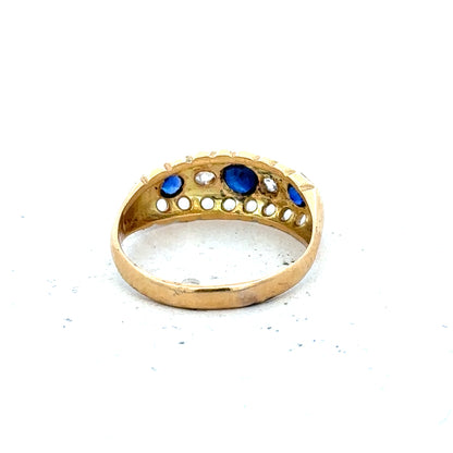 Vintage 18ct yellow gold sapphire and diamond ring with intricate design and gemstone detailing.