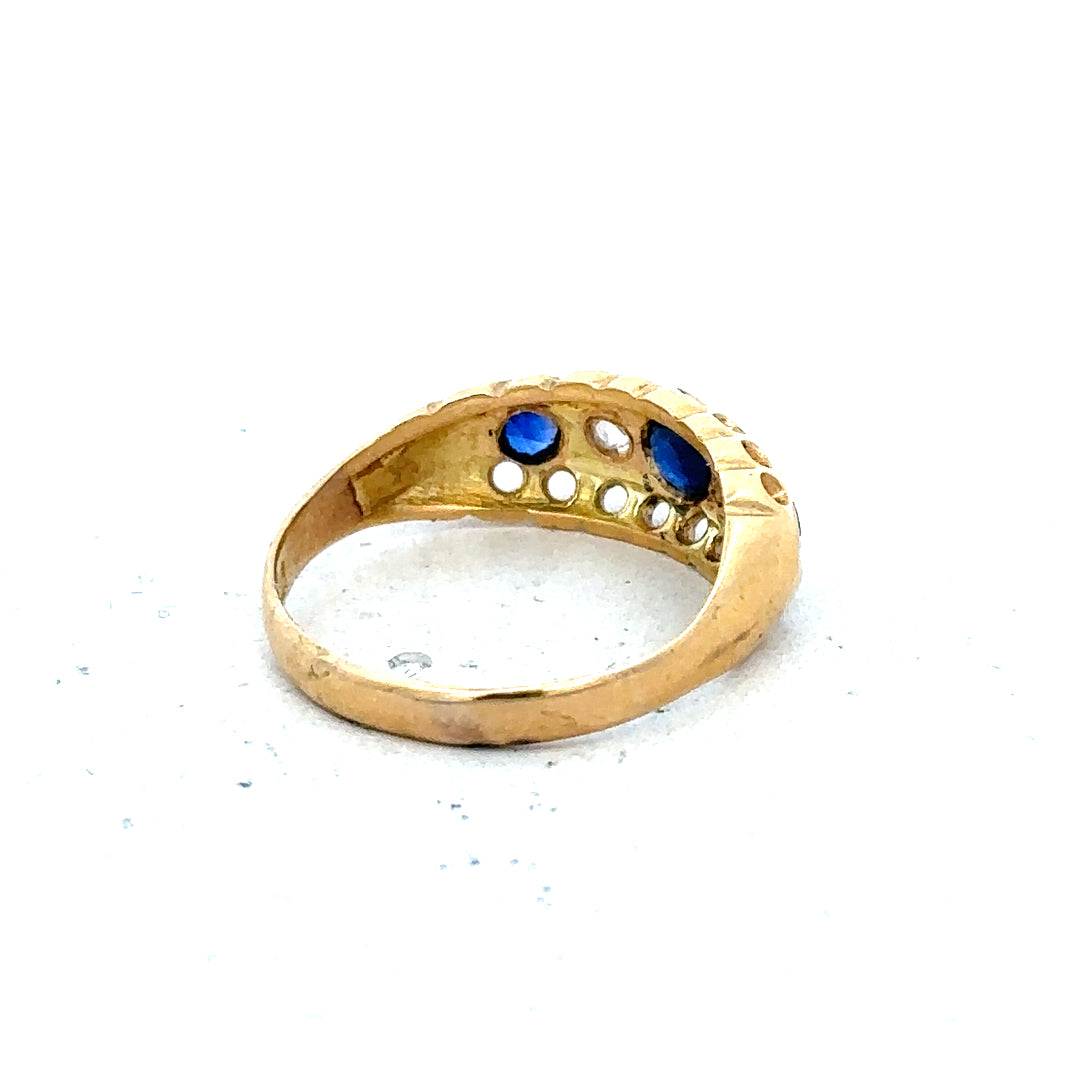 Vintage 18ct yellow gold sapphire and diamond ring with intricate detailing and classic design.