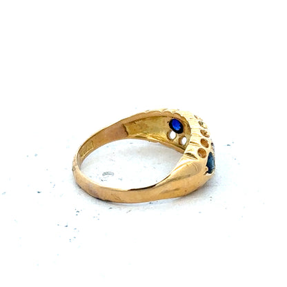Vintage 18ct yellow gold sapphire and diamond ring with intricate design and sparkling gemstones.